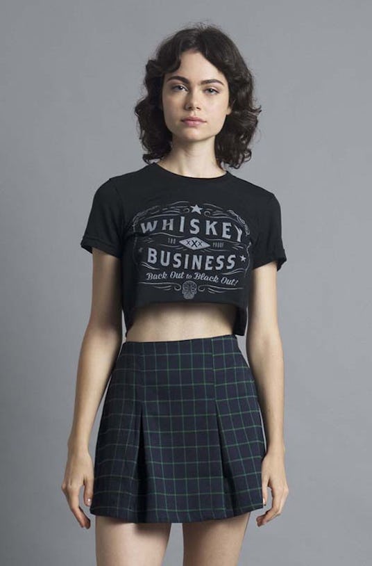 Woman wearing a Social Decay, Whiskey Business Crop Top and a plaid skirt
