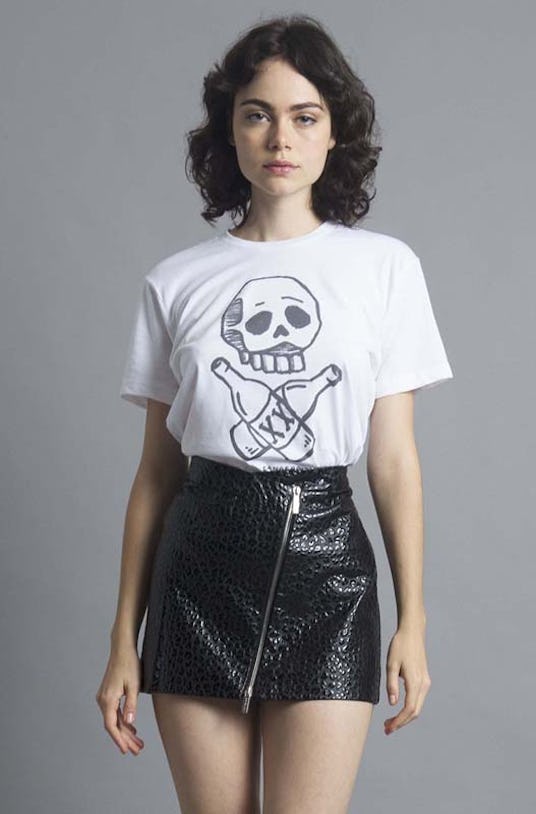 Woman in Kid Dangerous, Skulls and Beers Boyfriend Tee and a black leather skirt
