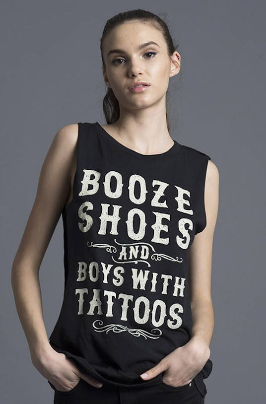 Woman in Social Decay, Booze and Boys Tank and black jeans