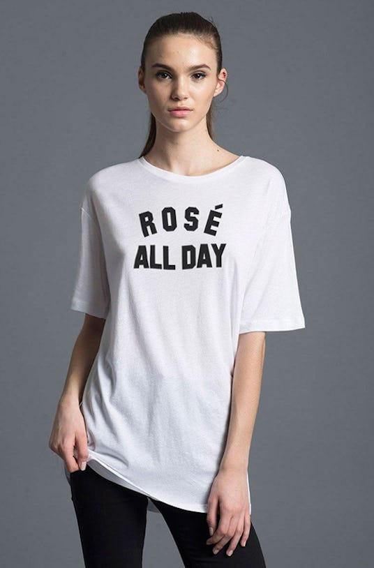 Woman in Kid Dangerous, Rosé All Day Tee and black pants