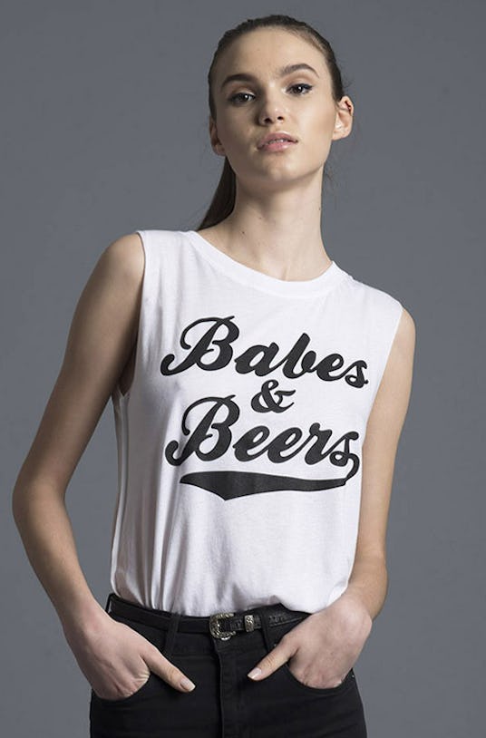 Woman in Social Decay, Babes and Beers shirt and black pants