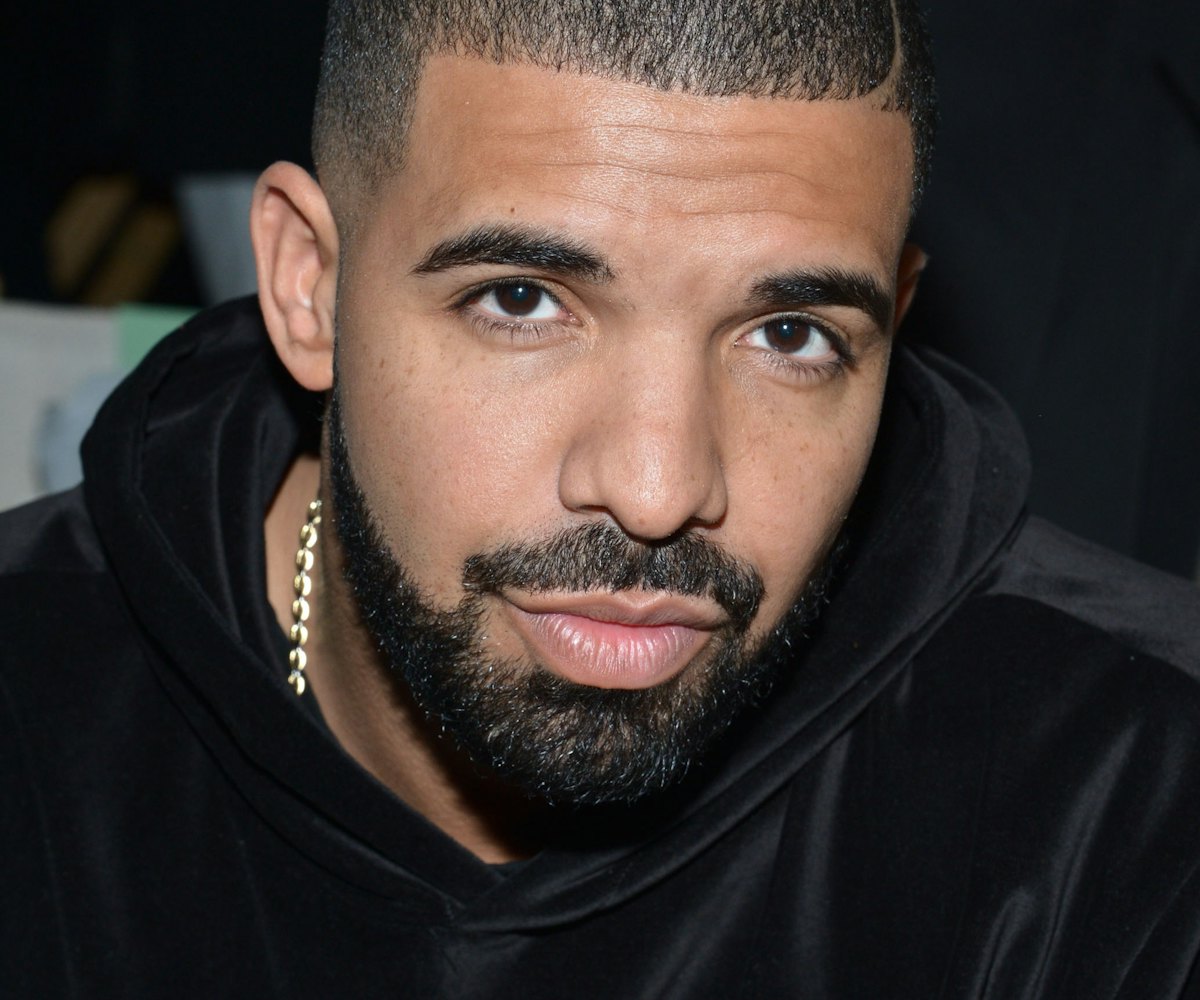 Drake wearing a black hoodie and a golden chain around his neck 