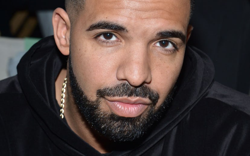 Drake wearing a black hoodie and a golden chain around his neck