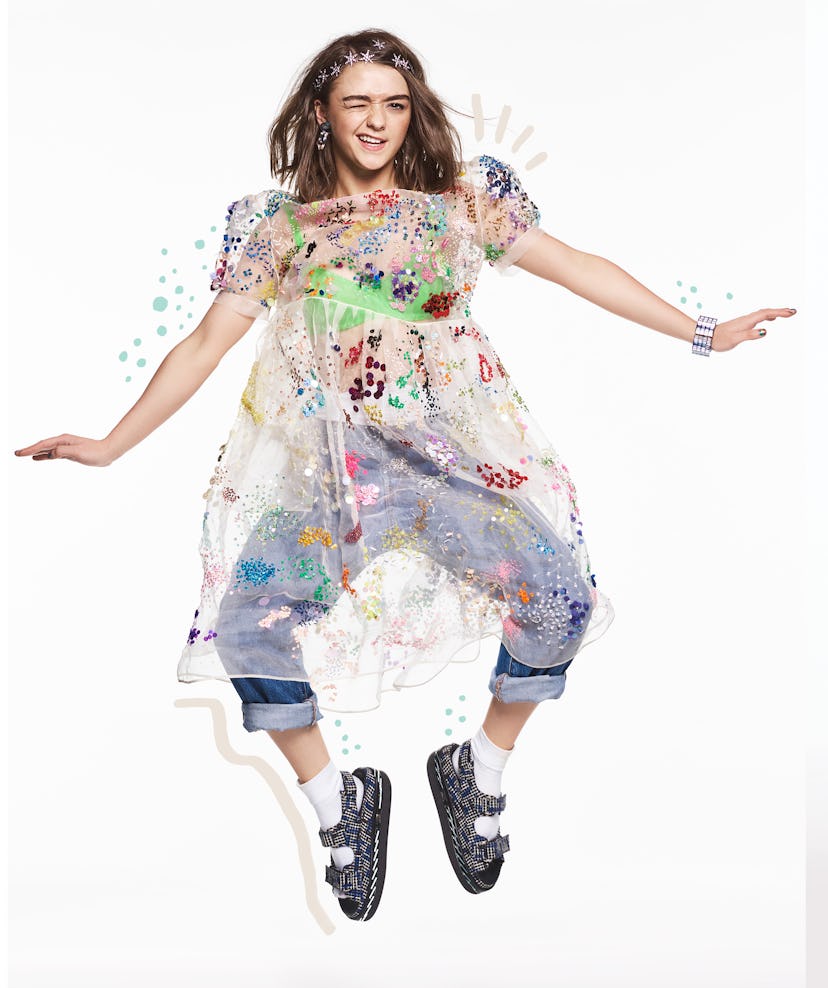 Maisie Williams jumping in a see-through dress going over Levi jeans, shoes and bracelet by Chanel, ...