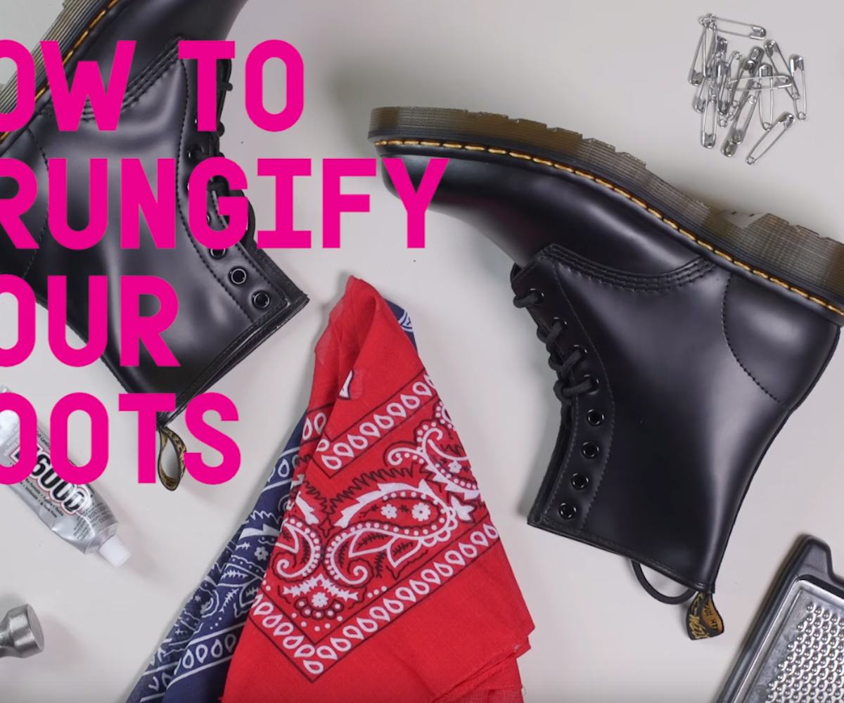 Pair of black DIY punk boots lying on the ground