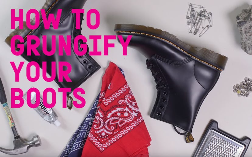Pair of black DIY punk boots lying on the ground