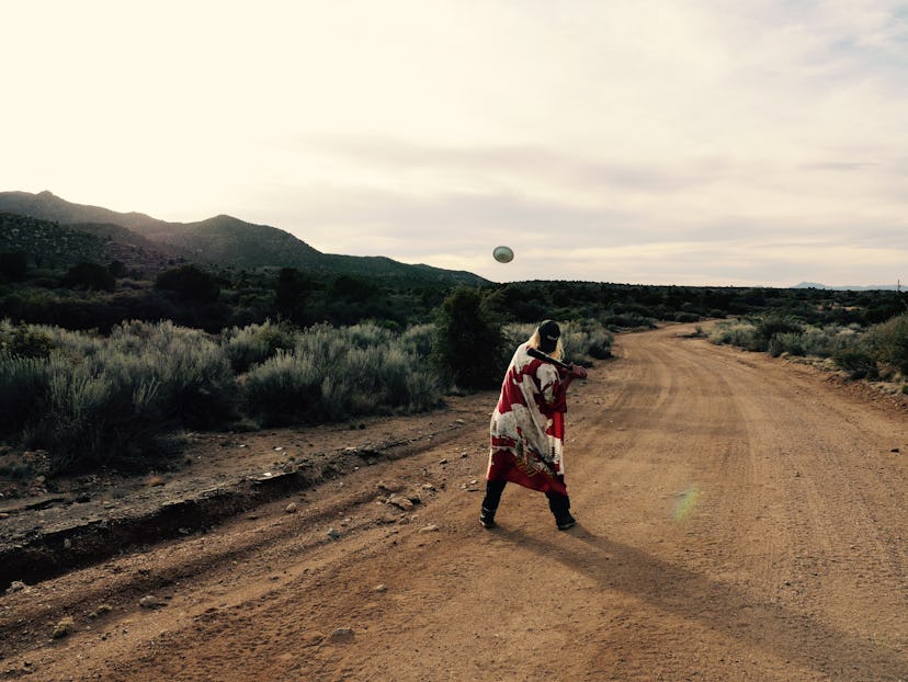 A Figs Vision band member about to hit a plate with the baseball bat outdoors