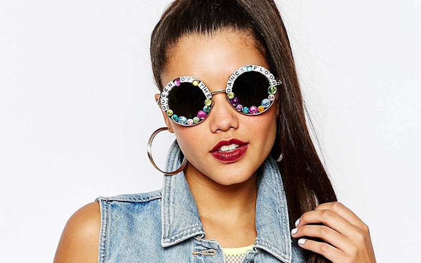 Woman with brown hair wearing a denim vest and Rad + Refined queen of the dance floor sunglasses