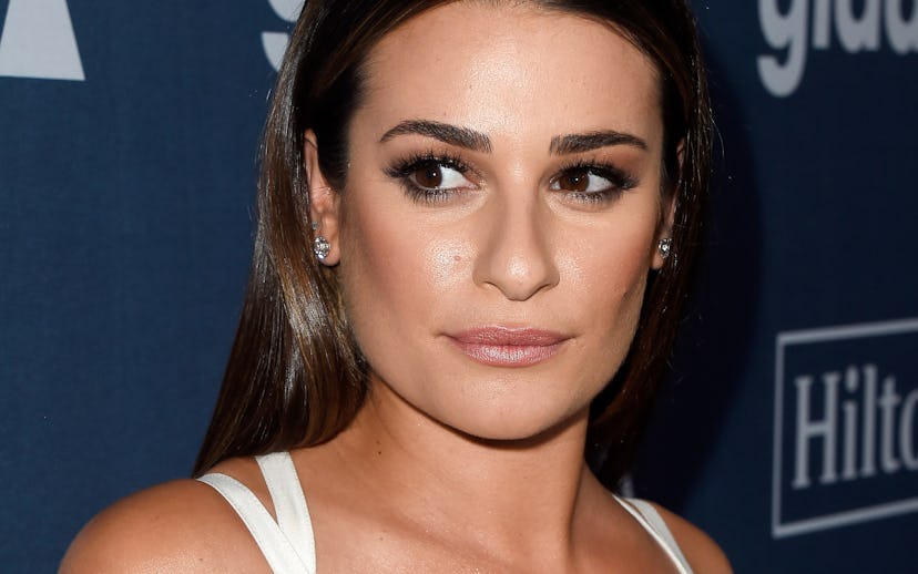 Lea Michelle posing in a white lace dress