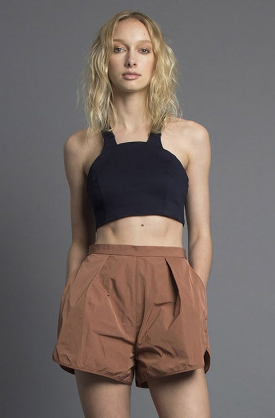A blonde female model wearing a brown Missy Skins’ Romeo Deep Pleat Shorts