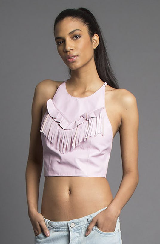 Model wearing a light pink top with fringes in front called "Die for You Cross Back Top",  from Miss...