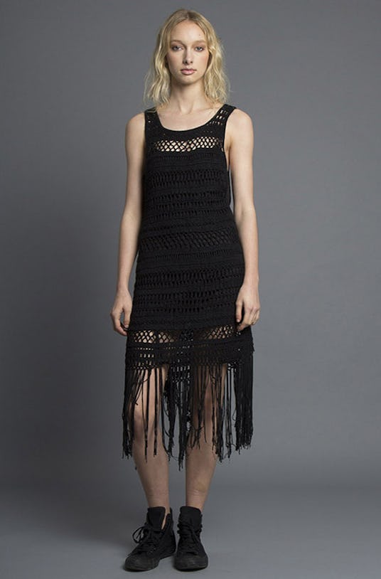 A blonde woman is wearing a black Athena Dress with a fringe detail from Nana Judy’s Spring 2016 Col...