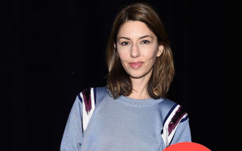 Sofia Coppola in a grey shirt with burgundy and white stripes on the shoulders