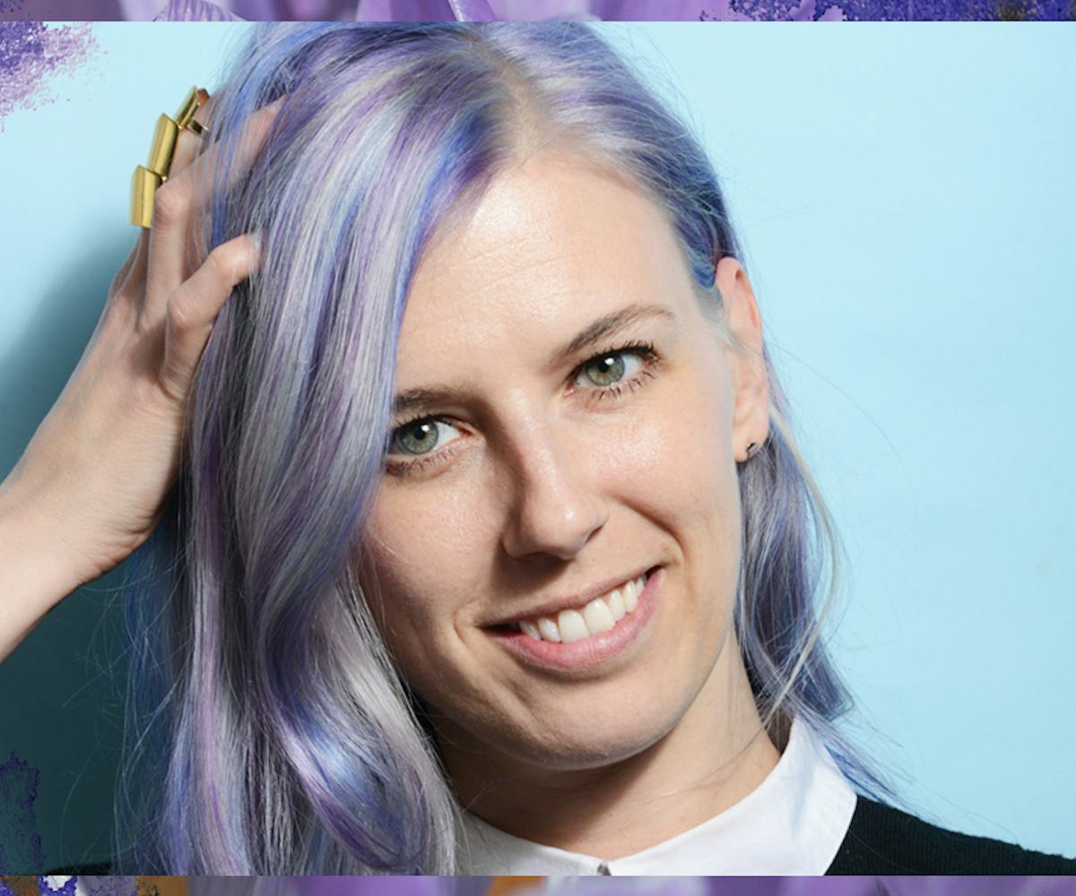 Julie Humeas holding her hand on her head and she has lilac-blue-silver highlighted hair