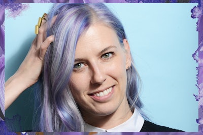 Julie Humeas holding her hand on her head and she has lilac-blue-silver highlighted hair