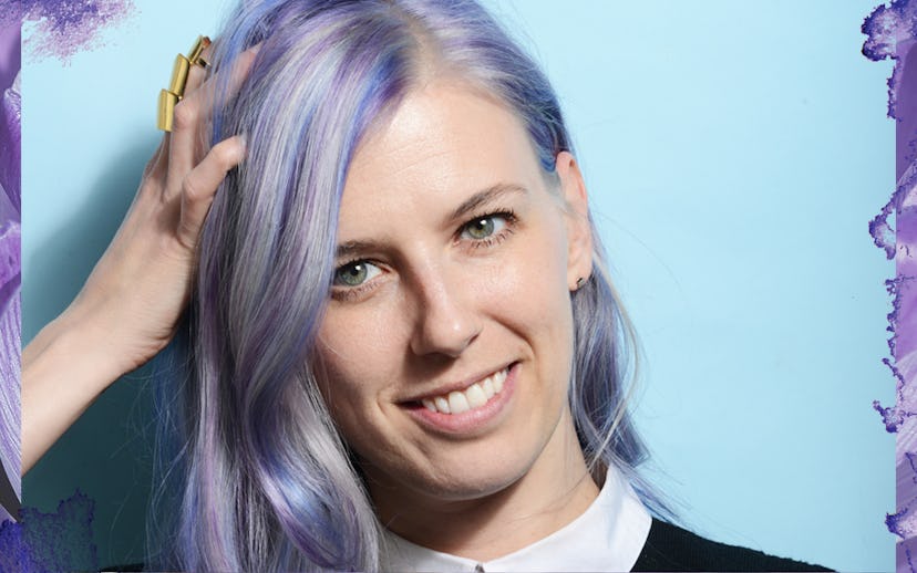Julie Humeas holding her hand on her head and she has lilac-blue-silver highlighted hair