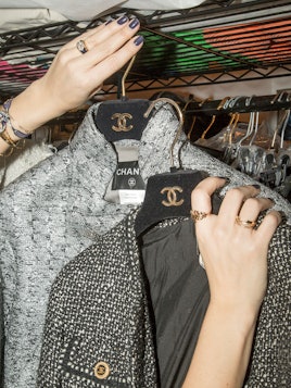 Dani Stahl holding a grey and a black Chanel blazer