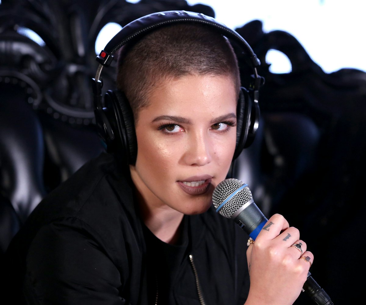 Halsey, a pop singer singing in an all black outfit with dark make-up
