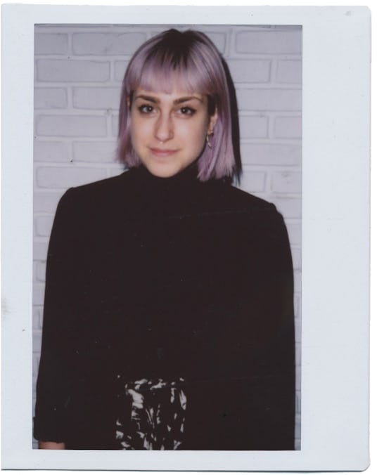 Girl with short violet hair and bangs wearing a black turtleneck