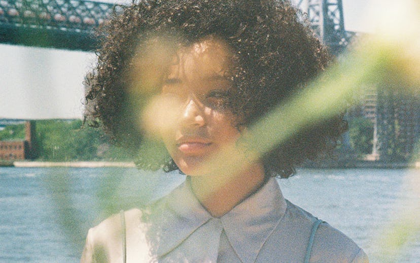 Blurred American actress Amandla Stenberg standing by the sea