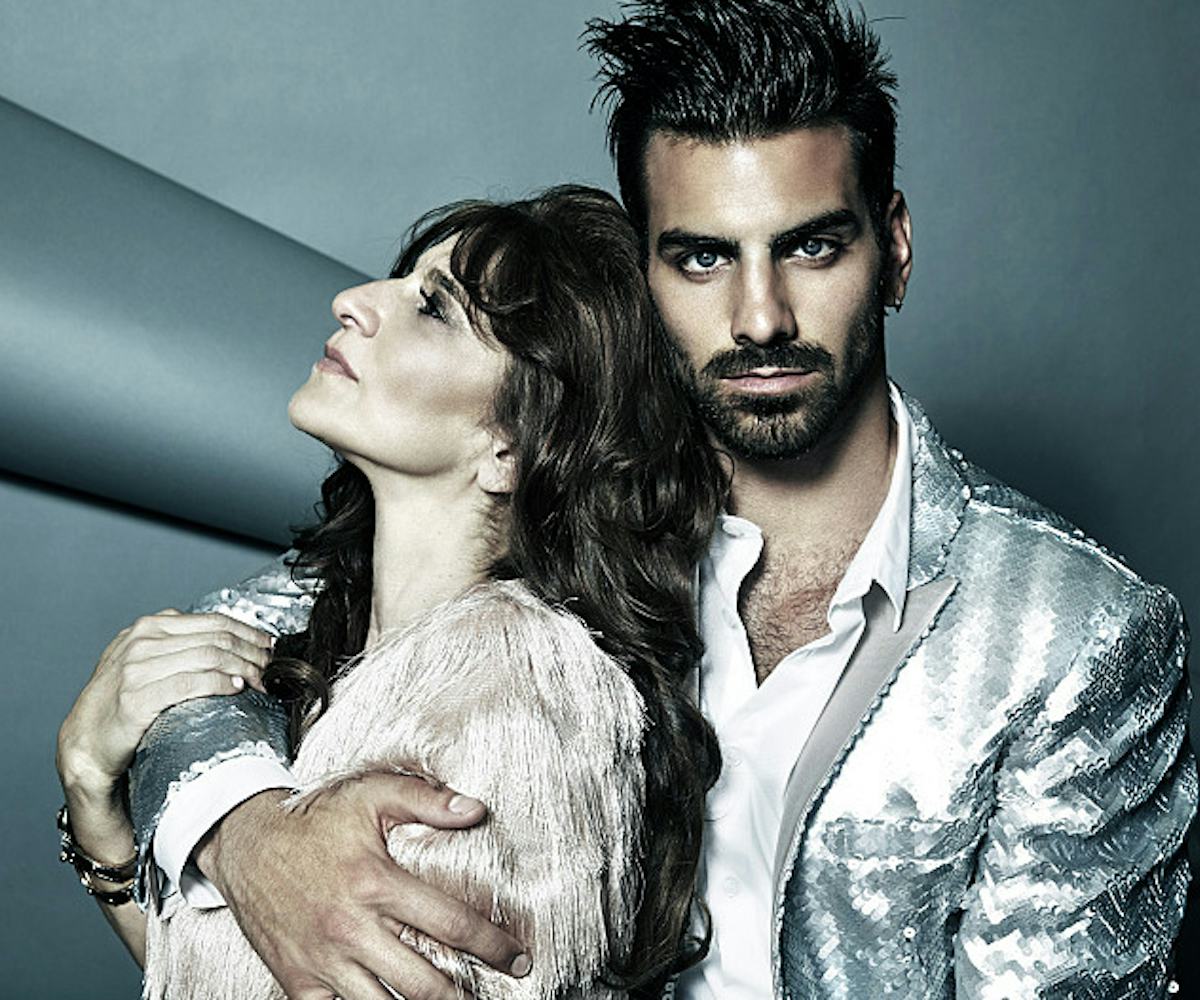 Nyle DiMarco hugging a woman with one hand at a photoshoot for America's Next Top Model