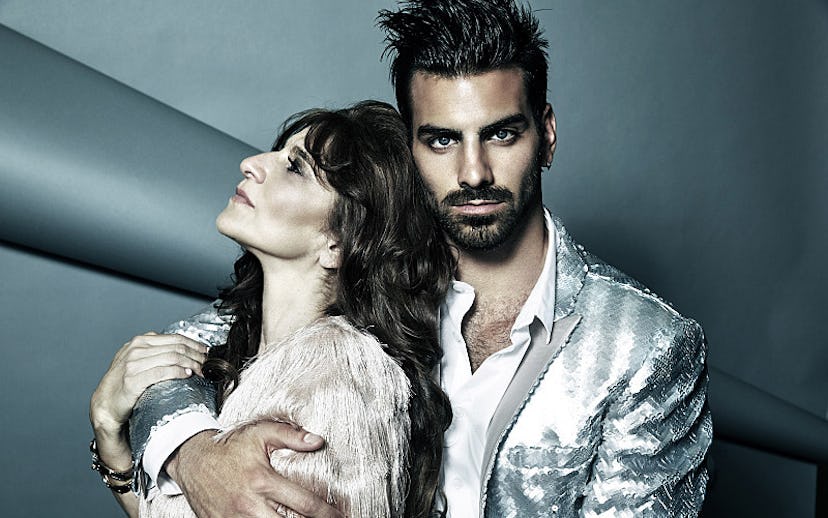 Nyle DiMarco hugging a woman with one hand at a photoshoot for America's Next Top Model