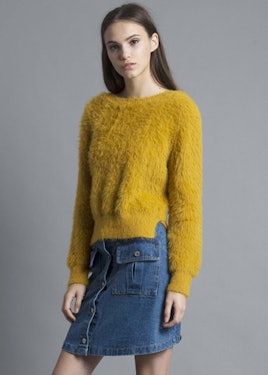 Brown-haired woman wearing a Shalex, Fluffy Yellow Jumper, and a denim skirt