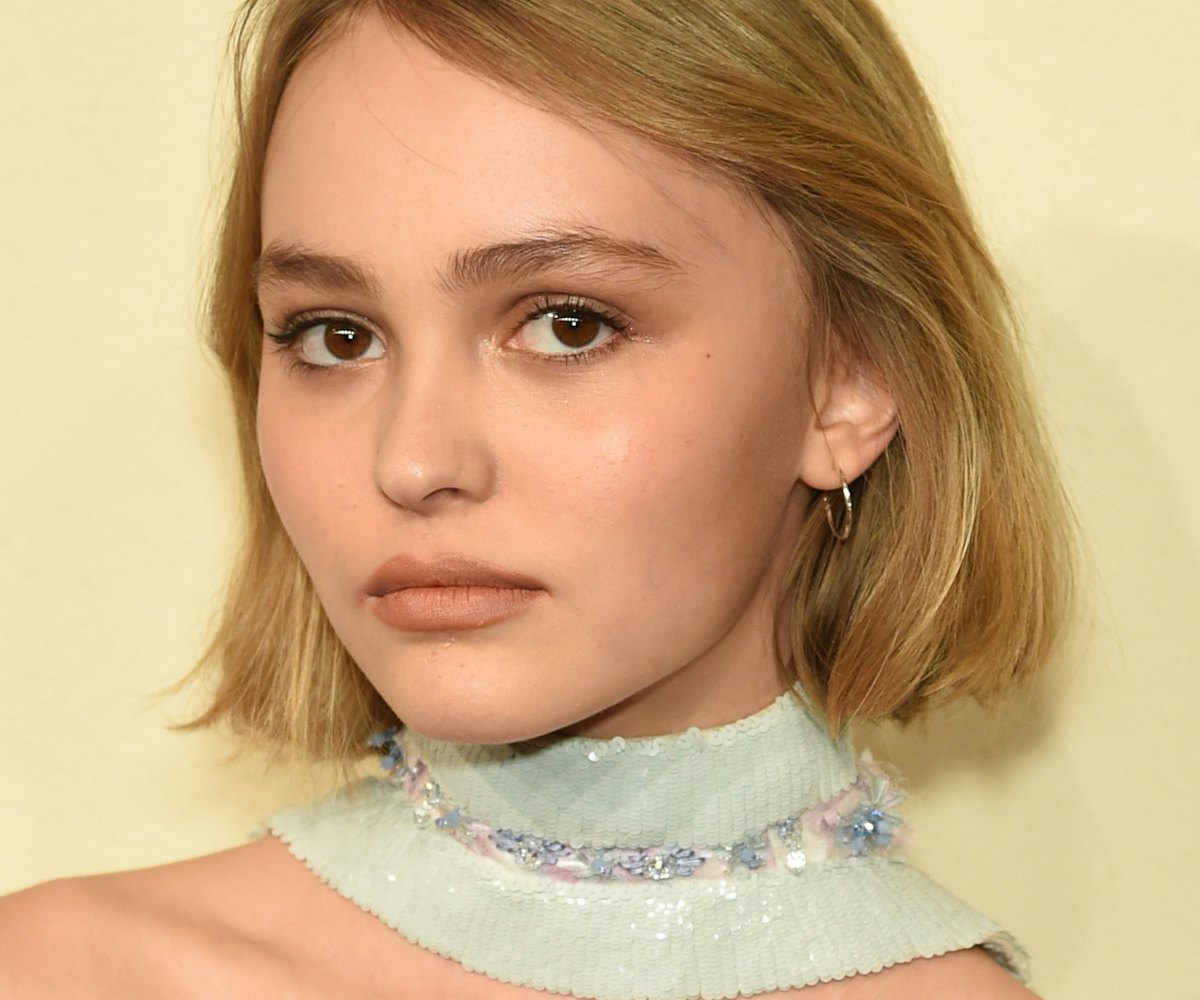 Lily-Rose Depp wearing a knit gray collar embellished with rhinestones which is part of her Chanel o...