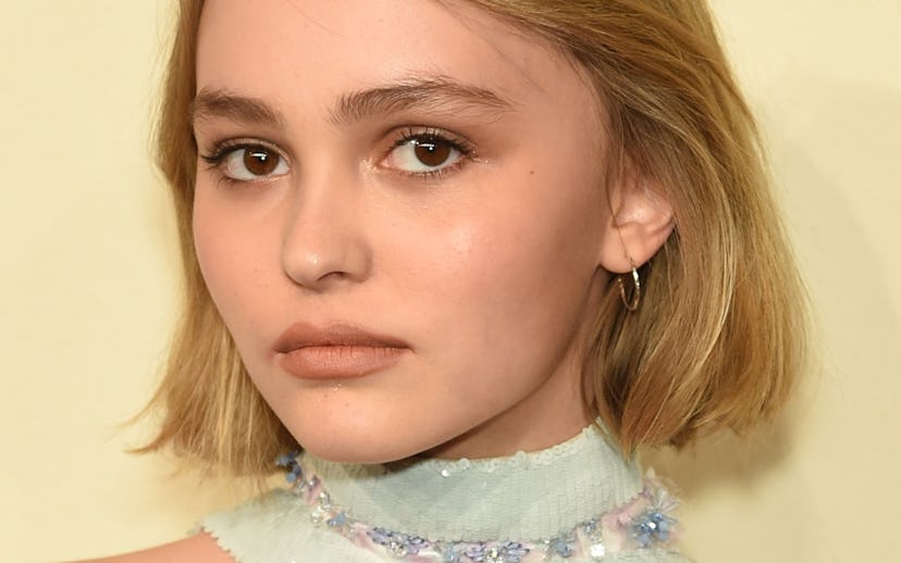 Lily-Rose Depp wearing a knit gray collar embellished with rhinestones which is part of her Chanel o...