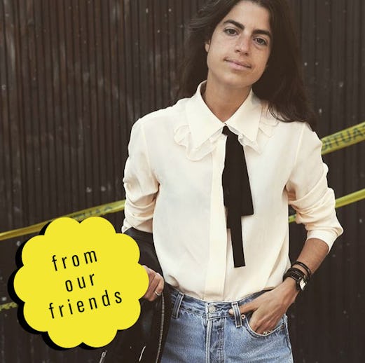 Leandra Medine in a ruffled white button-down, a black tie and jeans