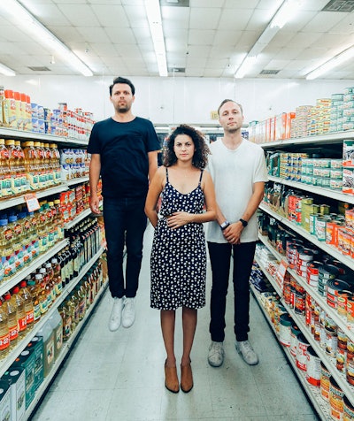 The superhumanoids standing in an aisle of a grocery store for their new single