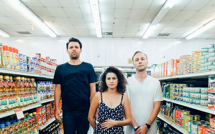 The Superhumanoids standing in an aisle of a grocery store for their new single
