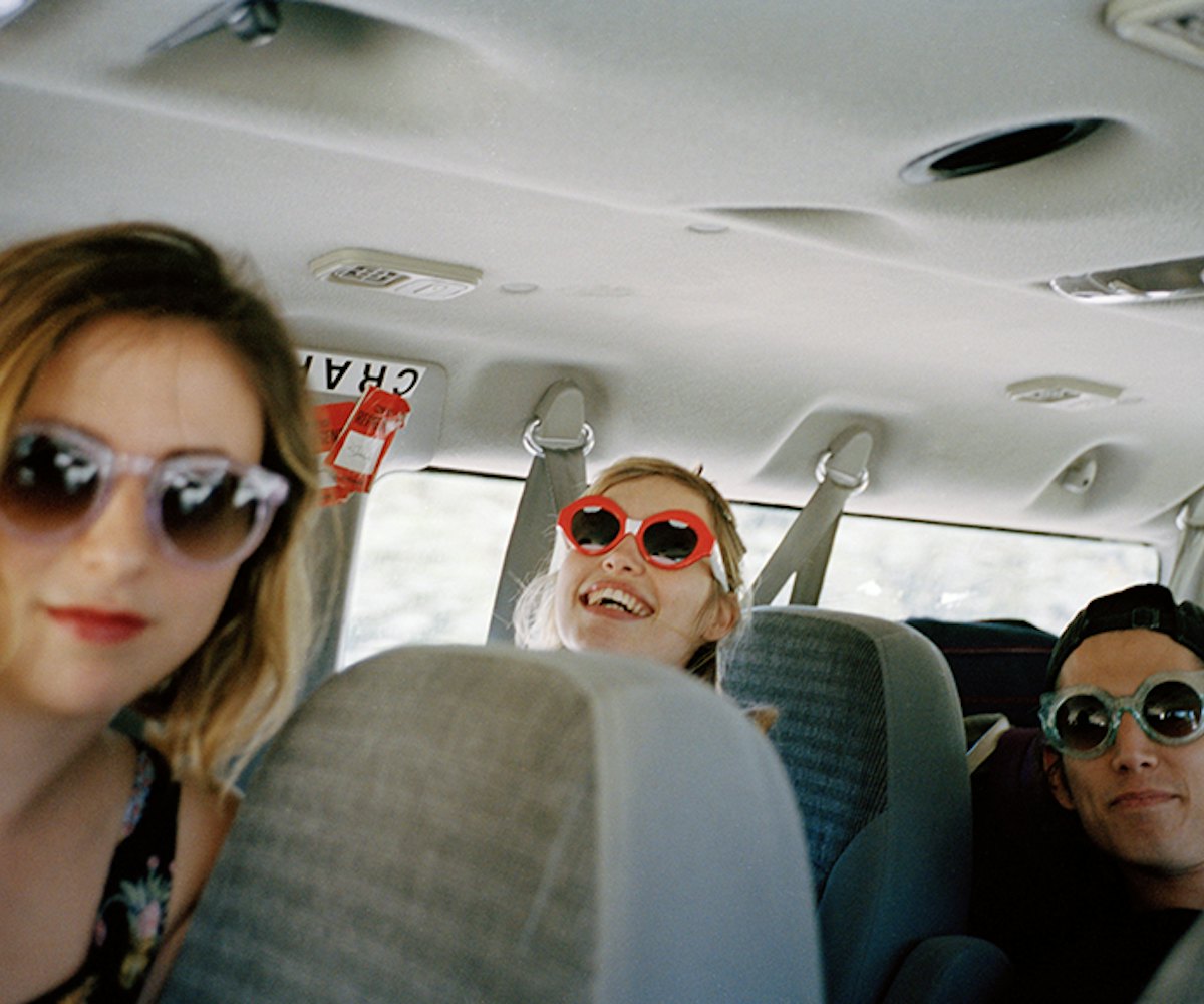 The Paranoids sitting in a van on a road trip wearing Crap Eyewear  