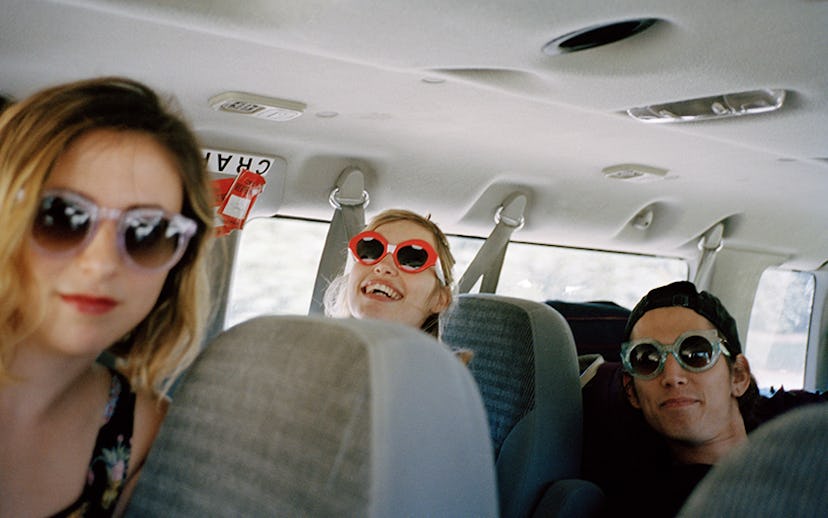 The Paranoids sitting in a van on a road trip wearing Crap Eyewear