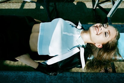 Model sunbathing in a shirt by ASOS, leather jacket and shorts by Carven