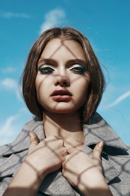Model wearing a grey jacket by Lacoste