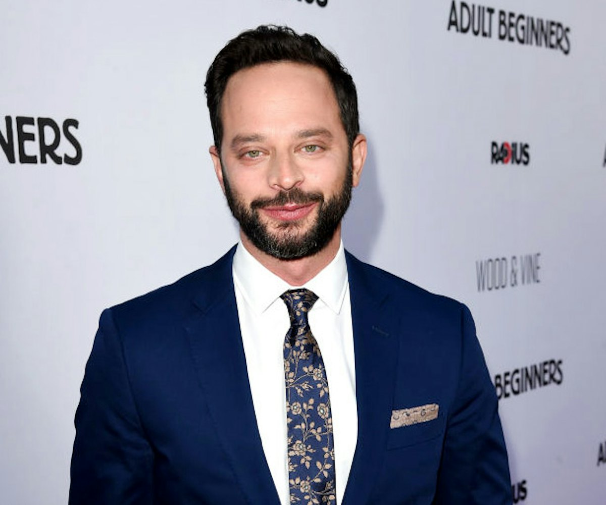 Nick Kroll in a suit and tie at a red carpet