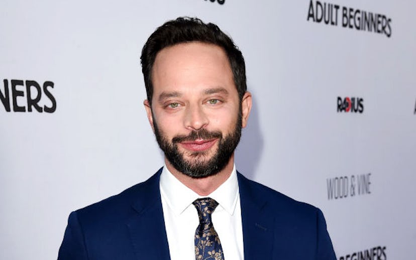 Nick Kroll in a suit and tie at a red carpet