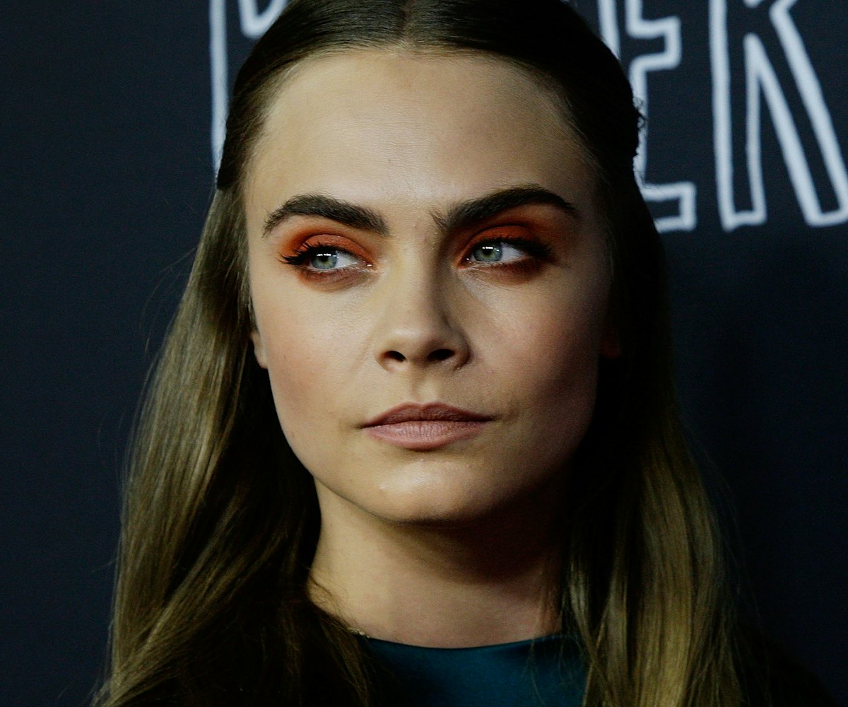 Cara Delevingne wears red eyeshadow on the red carpet
