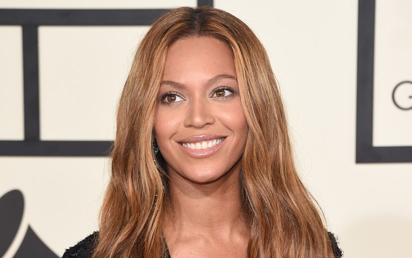 Beyoncé with honey-blonde hair in a black lace V-neck dress at the Grammy Awards