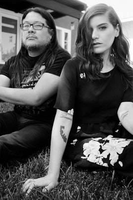 Bethany Cosentino and Bobb Bruno sitting on grass in a black and white photo