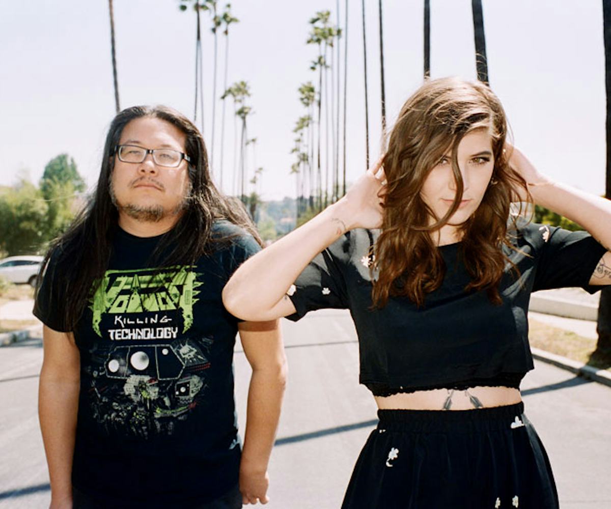 Bethany Cosentino and Bobb Bruno walking on a road with palm trees along each side