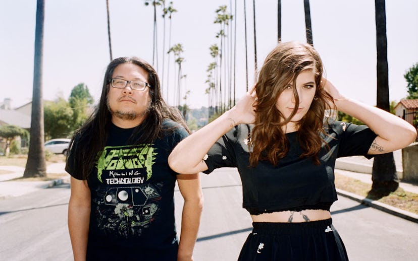 Bethany Cosentino and Bobb Bruno walking on a road with palm trees along each side