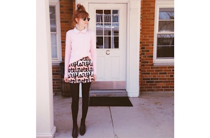 A model in the NYLON x Motel Rocks abstract cut-out skirt and a pink sweater with a button-up 