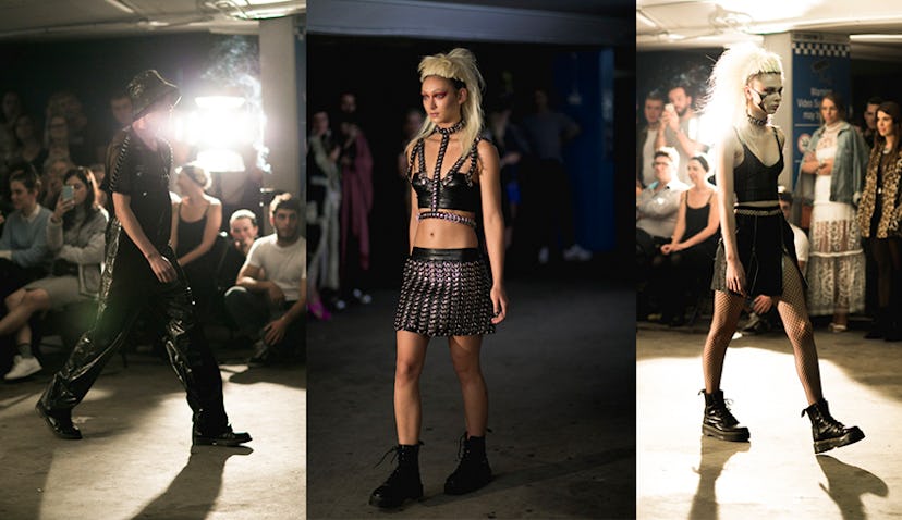 Three models wearing black grungy outfits on the runway