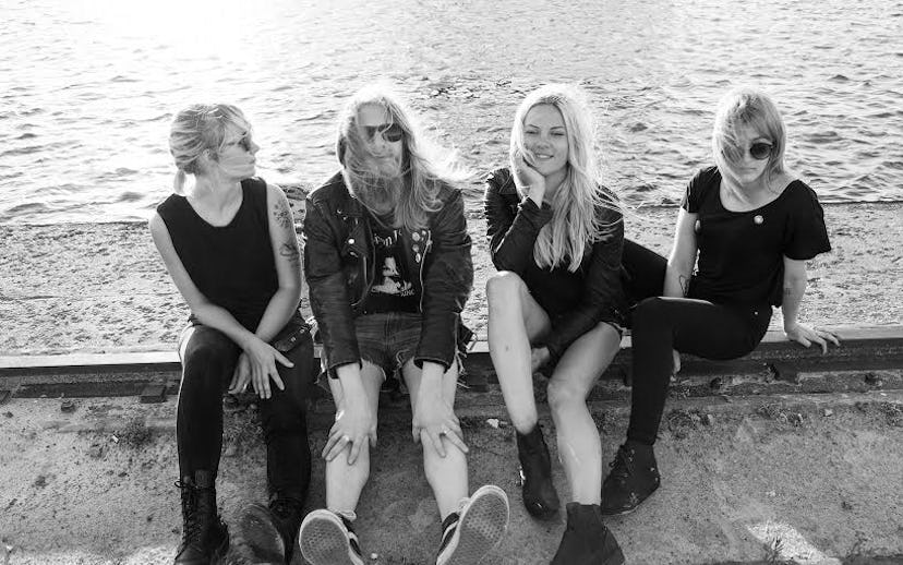 Group picture of Finnish band The Splits consisting of Helena, Maiju, Kiti and Aiju sitting by the s...