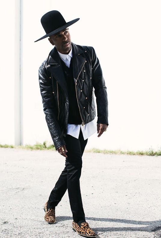 Big Sean in a black leather jacket, black hat and leopard-print shoes while walking 