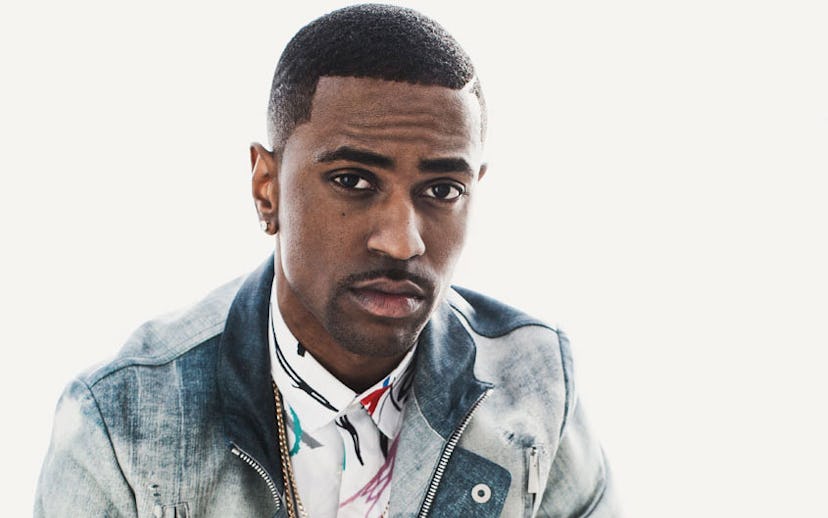 Big Sean in a blue and white denim jacket talking about his Rags to Riches story