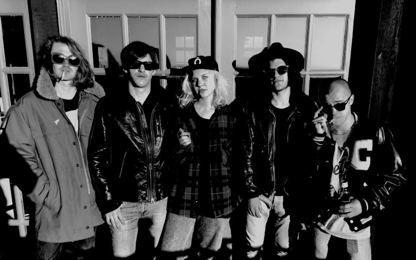 Acid Dad in psych-punk outfits posing for a photo