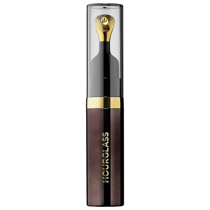 The Hourglass N° 28 lip treatment oil in dark translucent packaging with gold writing 